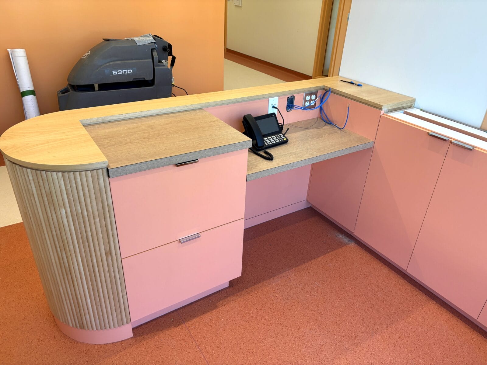 Modern reception desk with phone and cabinetry