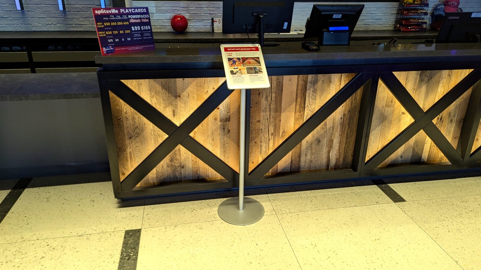 Bowling alley front desk with illuminated wood panels