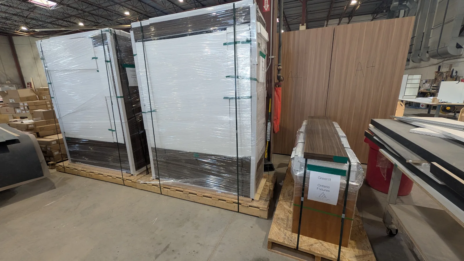 Finished store fixtures wrapped, strapped and labelled on crates for delivery from DNS
