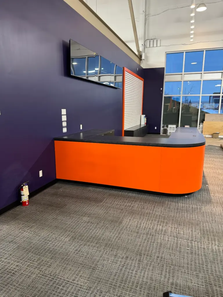 Curved front desk with slatwall backdrop at Pickleplex, Red Deer