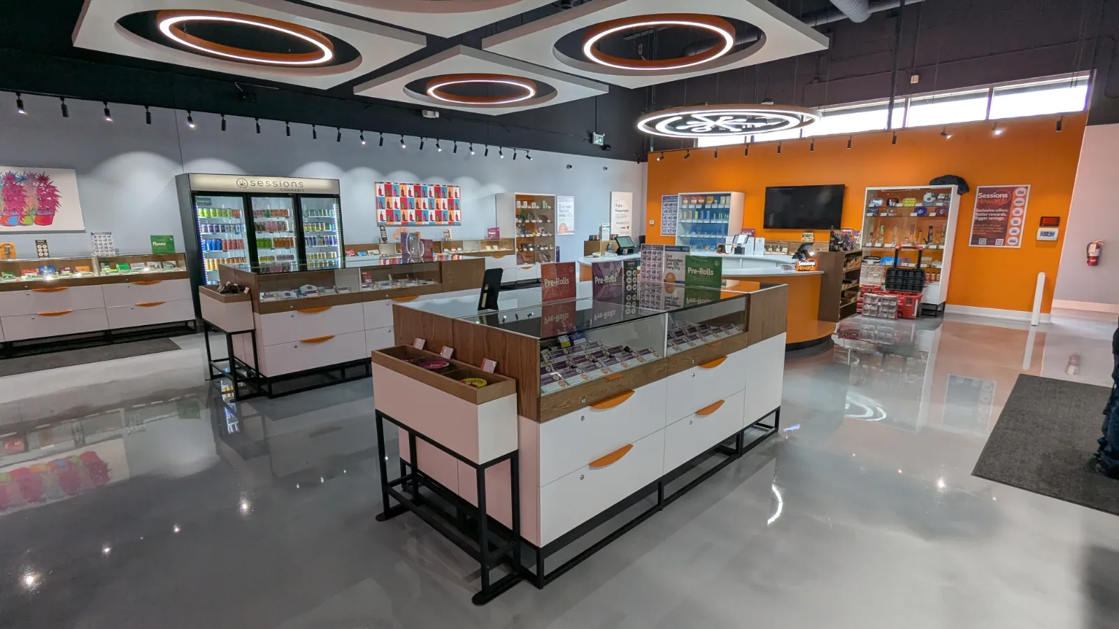 Island showcases with wood caps, white drawers and steel bases at Sessions Cannabis Cobourg