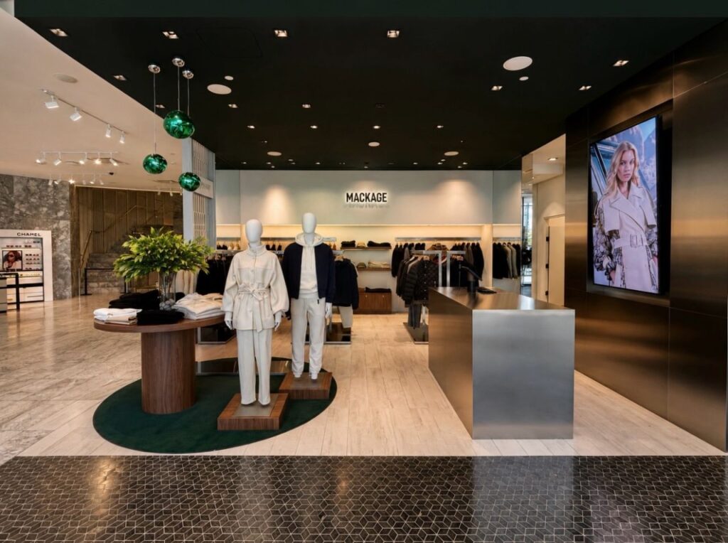 Mackage storefront fixtures with mannequin platforms and display portals