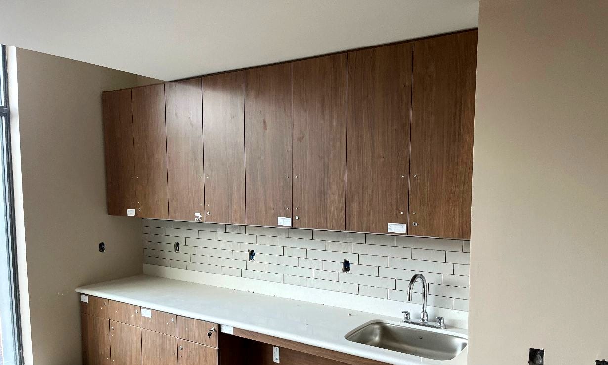 Modern kitchen cabinets with white countertop and sink