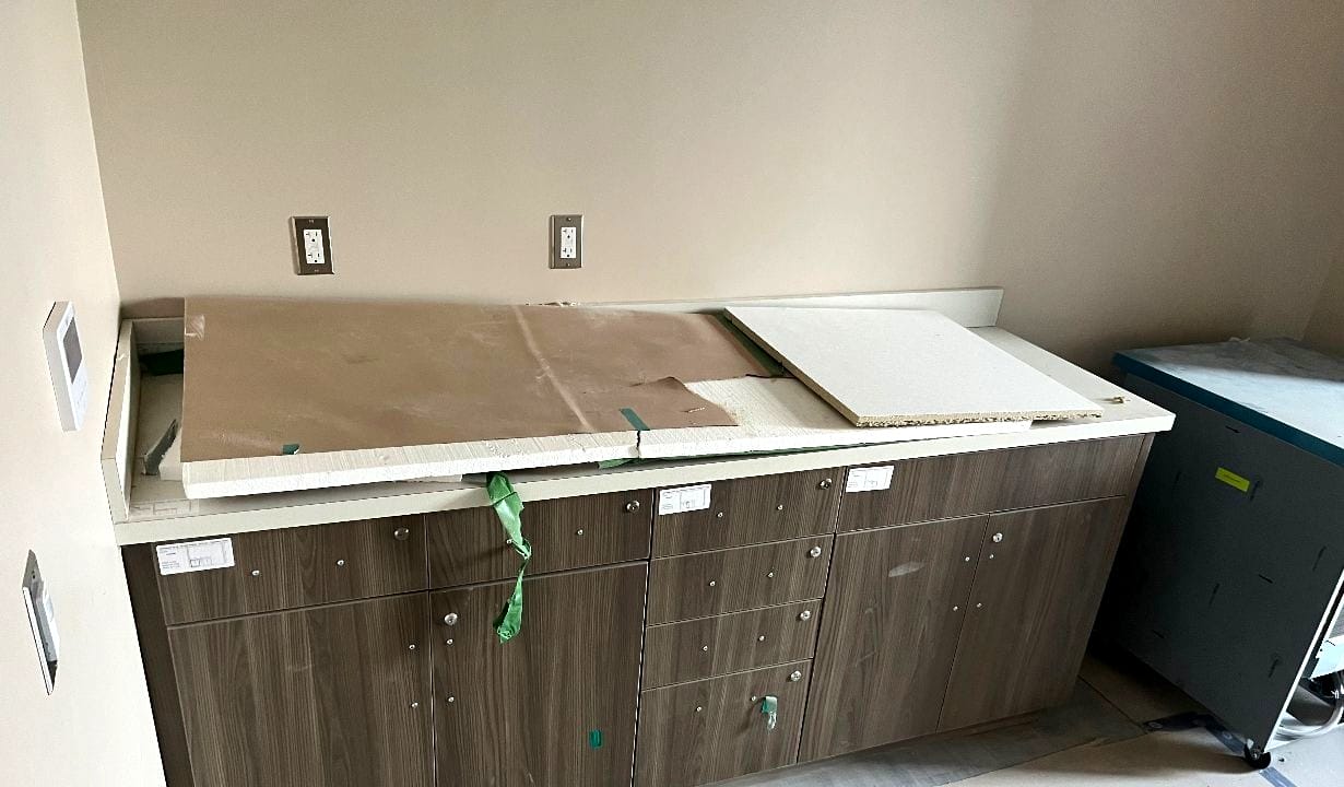 Partially installed kitchen cabinets with countertop pieces