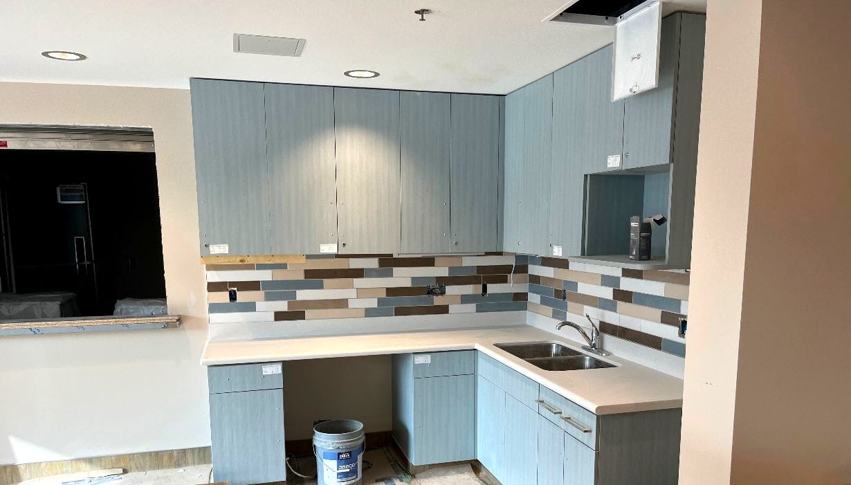 Modern kitchen with blue cabinets and tile backsplash