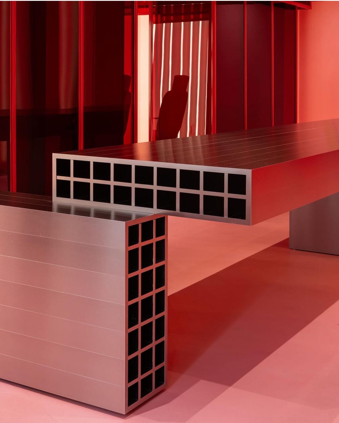 Red millwork storage unit with open cubbies at Pout