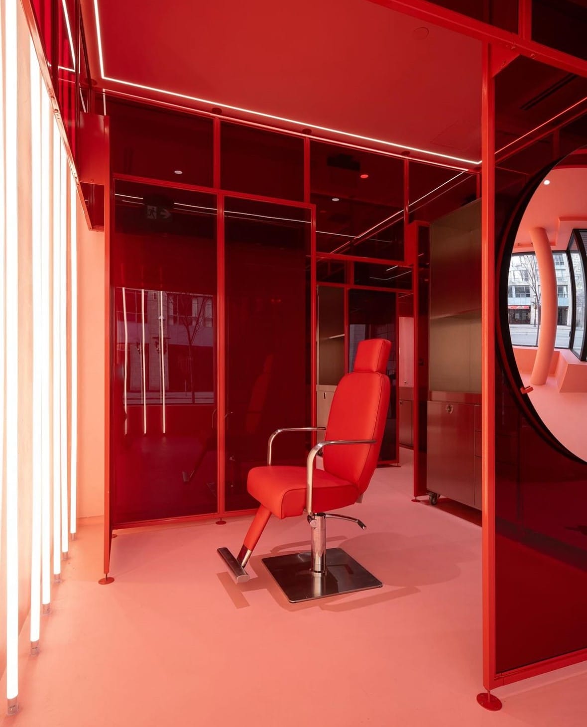 Red station at Pout with a red chair behind red acrylic partitions