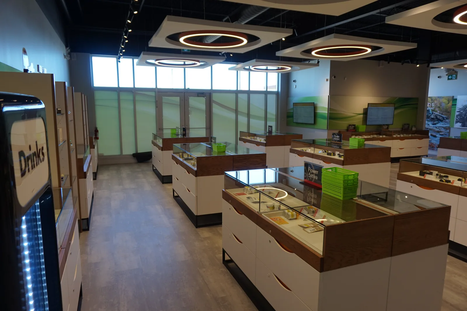 Sessions Cannabis Stoney Creek sales floor with white display counters, wood tops and glass cases on black bases